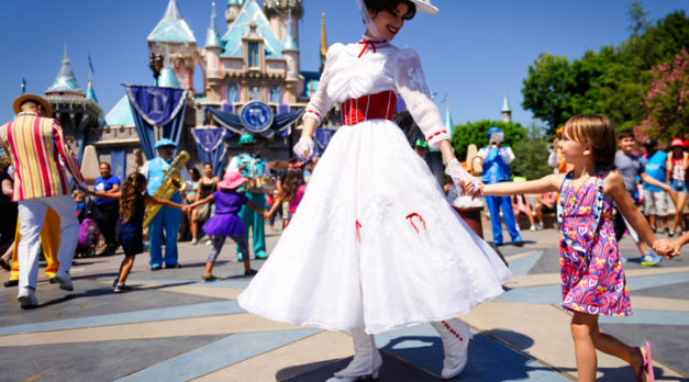 Anaheim, CA - August 10th 2016: Mary Poppins smiles at a young child as she leads a line of children in song and dance in front of Cinderella's castle during Disney's 60th Diamond Celebration.