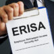 Man holds Employee Retirement Income Security Act ERISA.
