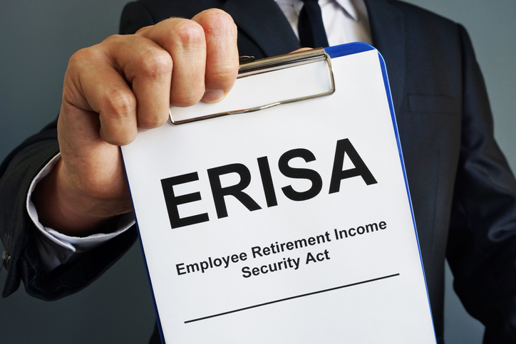 Man holds Employee Retirement Income Security Act ERISA.